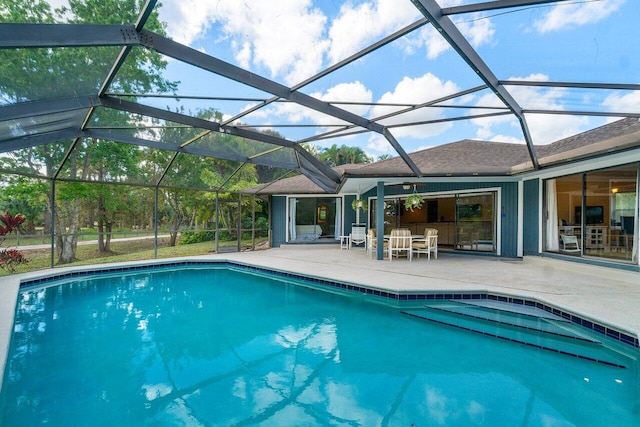 view of swimming pool featuring a patio and a lanai