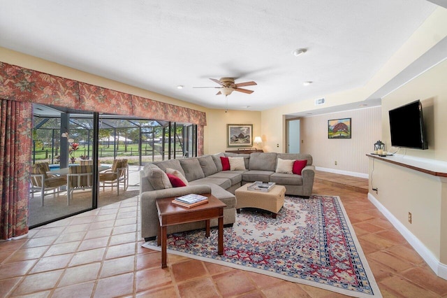 tiled living room with ceiling fan