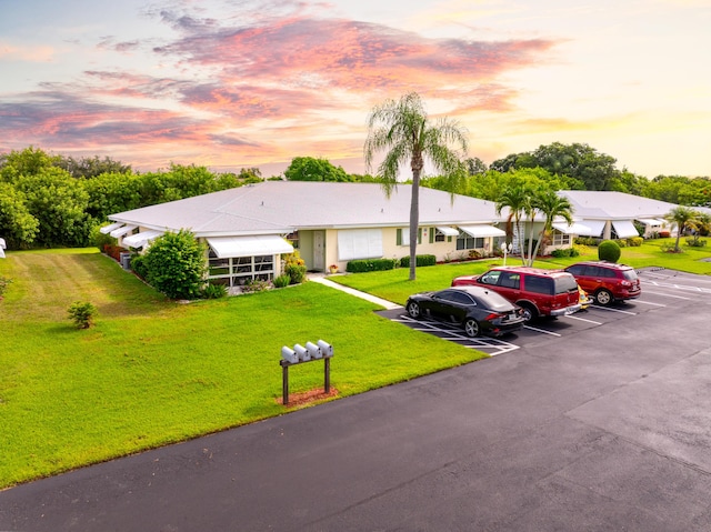 single story home featuring a yard