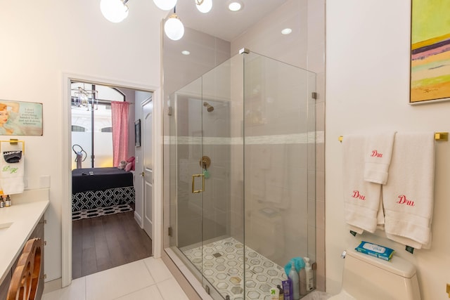 bathroom featuring a shower with shower door, tile patterned floors, and vanity