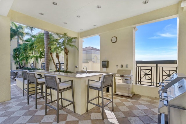 view of patio with a bar and area for grilling