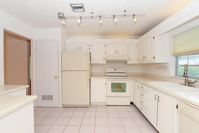 kitchen featuring a textured ceiling, white appliances, sink, white cabinets, and light tile patterned flooring