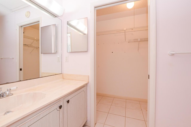 bathroom with tile patterned floors and vanity