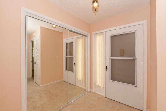 hallway featuring a textured ceiling