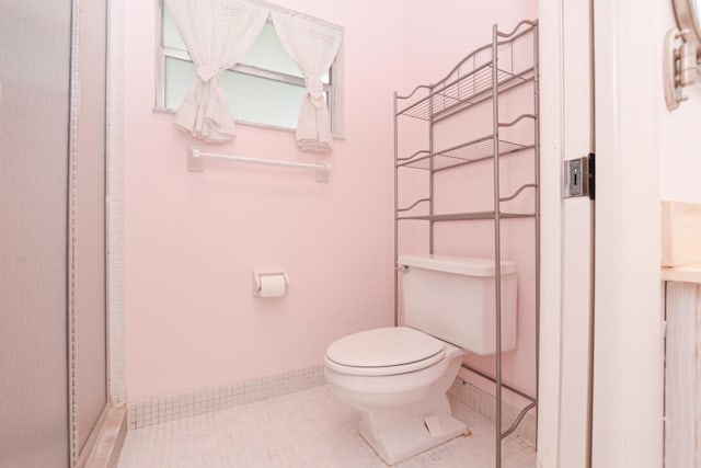 bathroom featuring tile patterned flooring and toilet