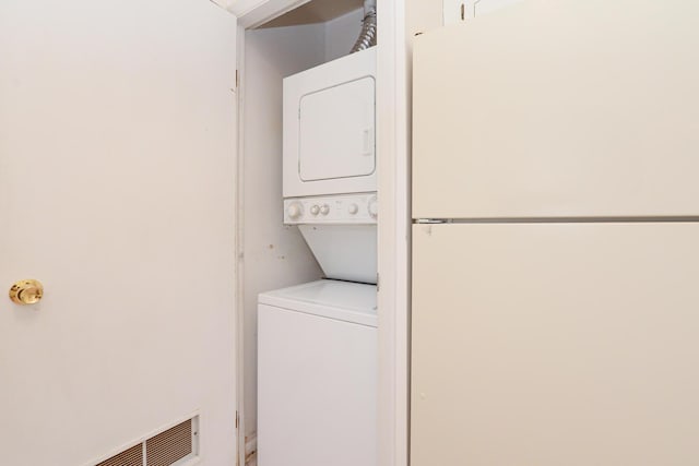 laundry room featuring stacked washing maching and dryer