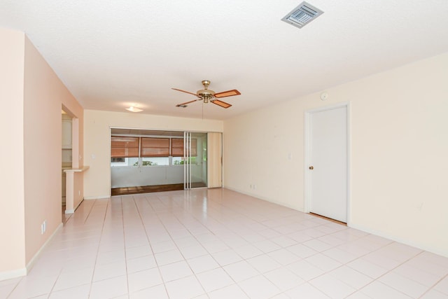 tiled spare room featuring ceiling fan and a textured ceiling