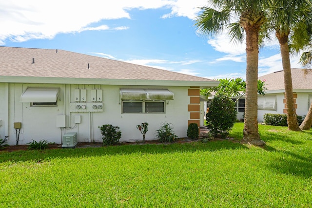 back of property featuring a yard