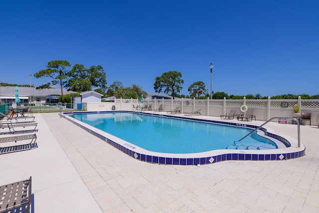 view of swimming pool with a patio