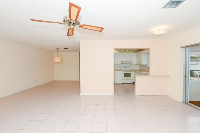 unfurnished living room with light tile patterned floors and a textured ceiling