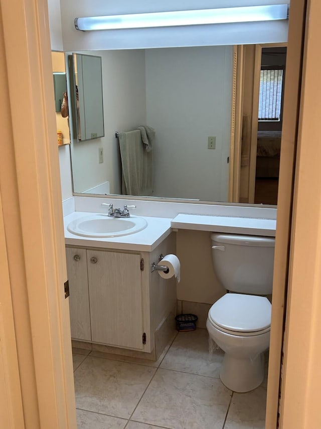 bathroom featuring tile patterned floors, vanity, and toilet