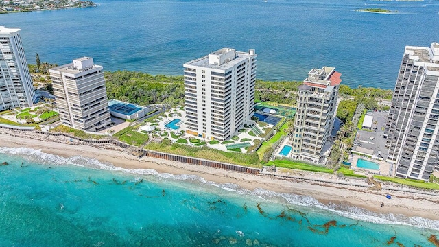 drone / aerial view with a water view and a beach view