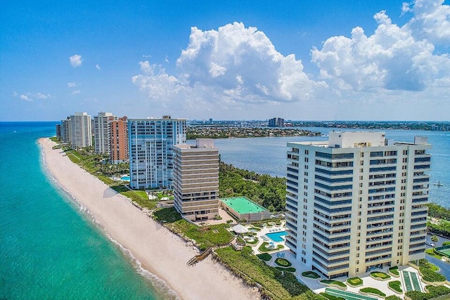 drone / aerial view featuring a beach view and a water view