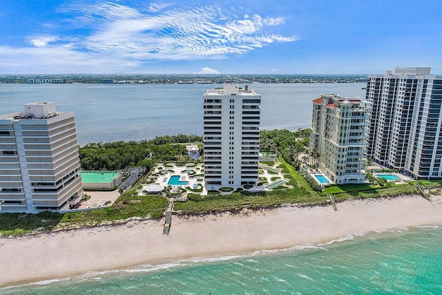 bird's eye view with a water view and a beach view