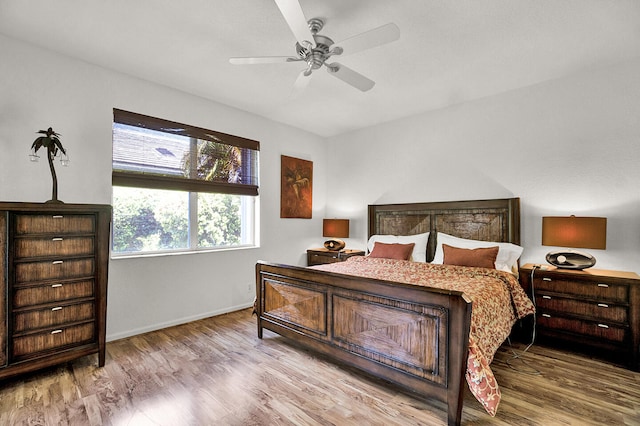 bedroom with baseboards, wood finished floors, and a ceiling fan