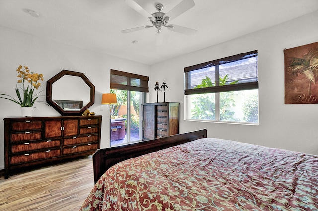 bedroom featuring wood finished floors, ceiling fan, and access to exterior
