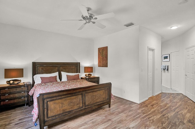bedroom with wood finished floors, a ceiling fan, and baseboards
