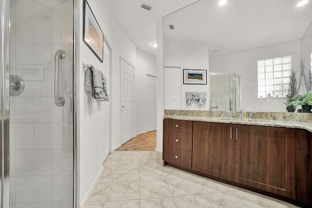 full bathroom featuring a stall shower, marble finish floors, vanity, baseboards, and recessed lighting