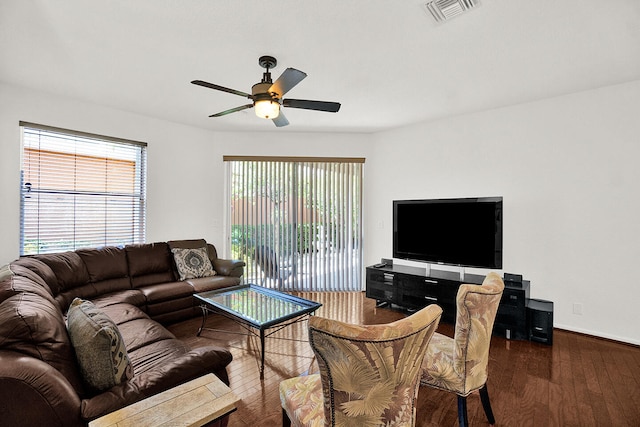 living room with ceiling fan, wood finished floors, and baseboards