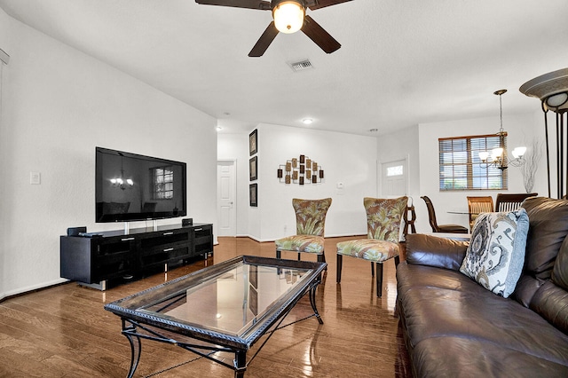living room with a chandelier, a ceiling fan, wood finished floors, and baseboards