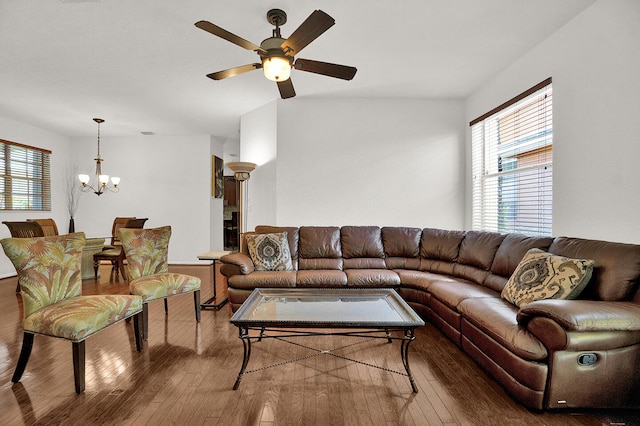 living area with hardwood / wood-style flooring, a chandelier, and ceiling fan