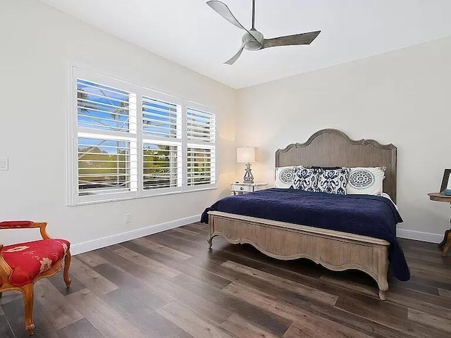 bedroom featuring a ceiling fan, baseboards, and wood finished floors