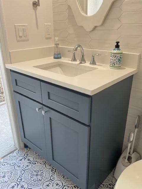 bathroom featuring tile patterned flooring and vanity