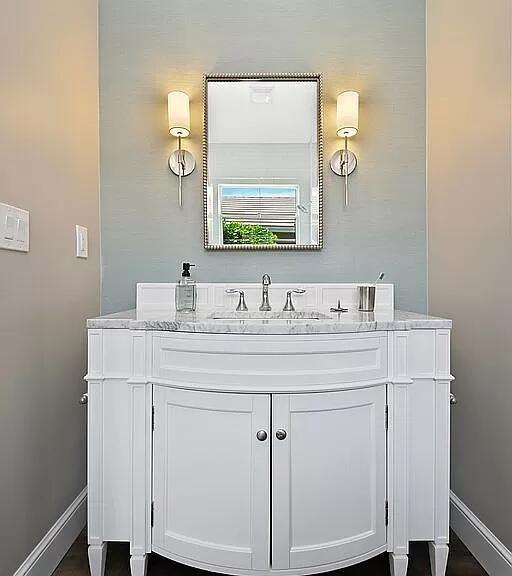 bathroom with vanity and baseboards