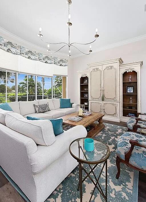 living room featuring crown molding and wood finished floors