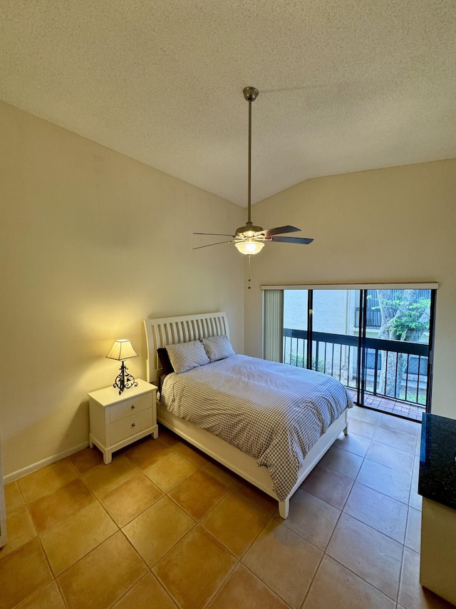 tiled bedroom featuring a water view, vaulted ceiling, ceiling fan, access to exterior, and a textured ceiling