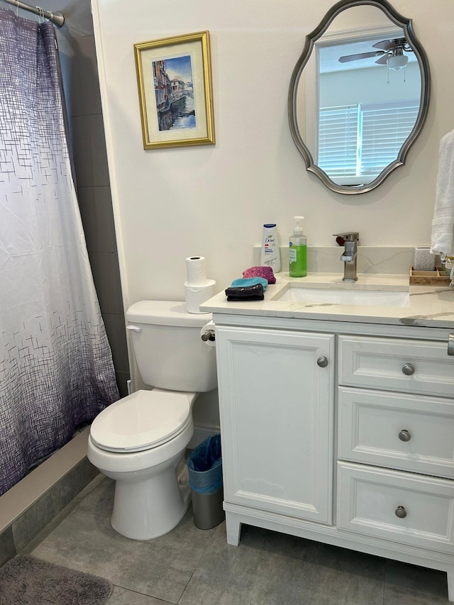 bathroom featuring vanity, tile patterned flooring, ceiling fan, and toilet