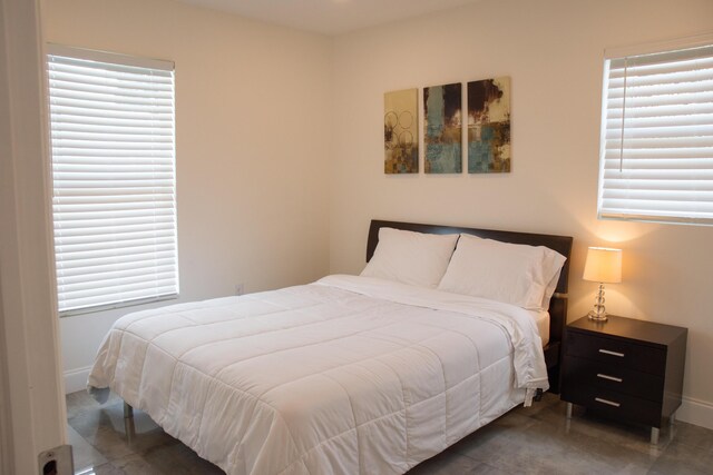 bedroom featuring dark tile patterned flooring