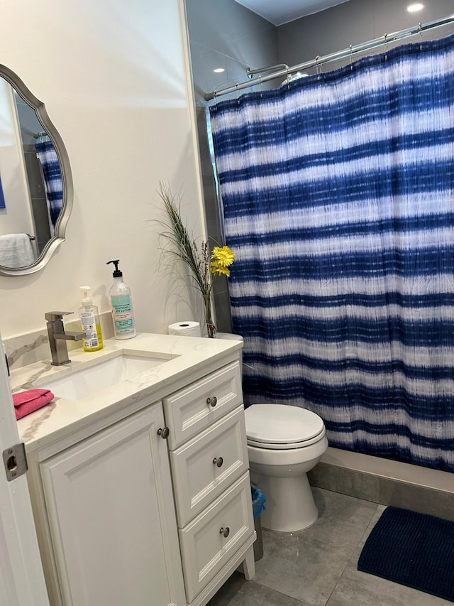 bathroom with vanity, toilet, and tile patterned floors