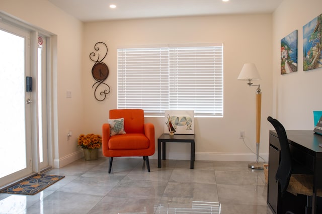 living area with a healthy amount of sunlight and light tile patterned floors