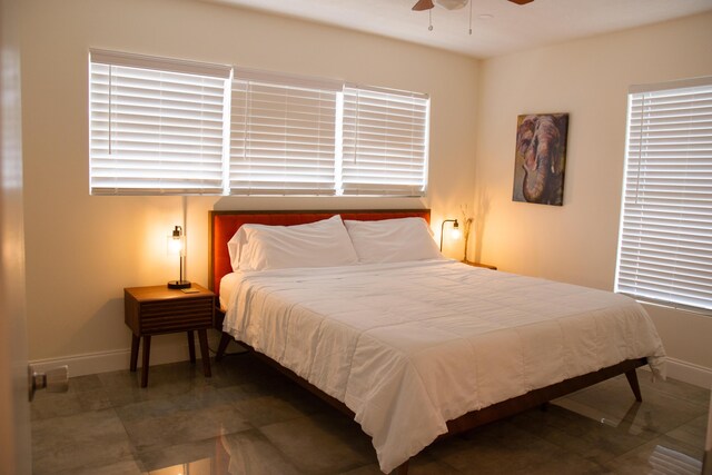 bedroom with ceiling fan and tile patterned floors