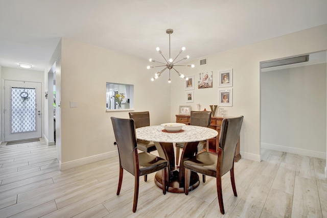 2004 Granada Dr Unit L2, Coconut Creek, FL 33066 - dining room featuring light wood finished floors, baseboards, and a chandelier
