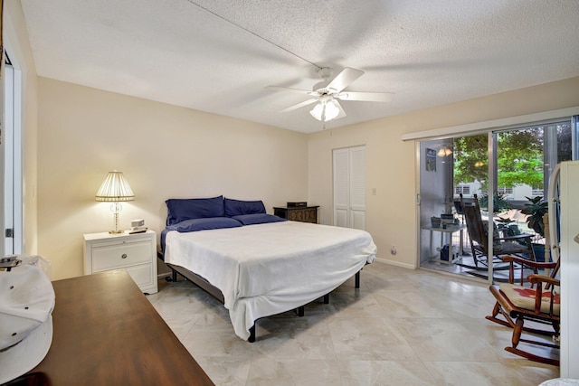 2004 Granada Dr Unit L2, Coconut Creek, FL 33066 - bedroom featuring access to exterior, a textured ceiling, a closet, a ceiling fan, and baseboards