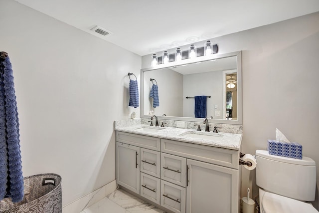 2004 Granada Dr Unit L2, Coconut Creek, FL 33066 - full bathroom featuring marble finish floors, toilet, double vanity, and baseboards
