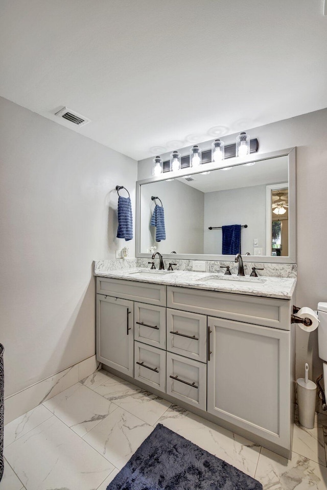 bathroom featuring double vanity, tile patterned flooring, and toilet