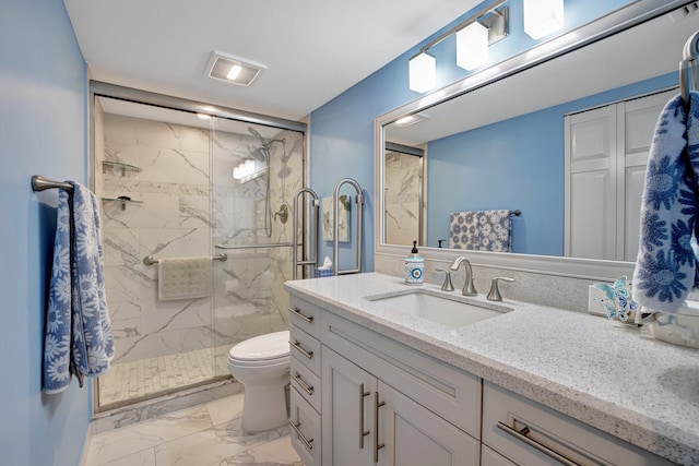 bathroom with tile patterned floors, toilet, vanity, and an enclosed shower