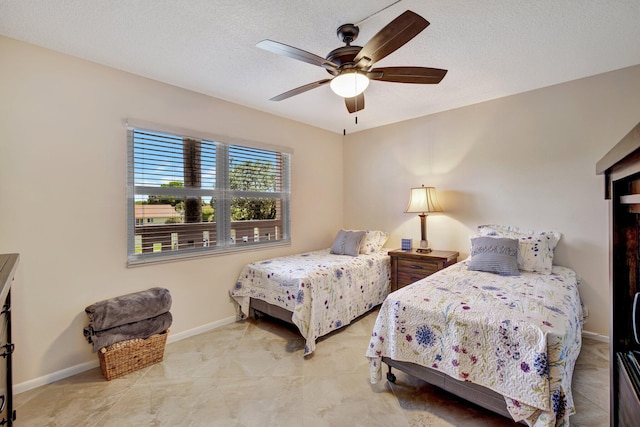 bedroom featuring tile patterned flooring, a textured ceiling, and ceiling fan