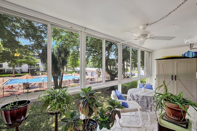 sunroom featuring ceiling fan and a healthy amount of sunlight