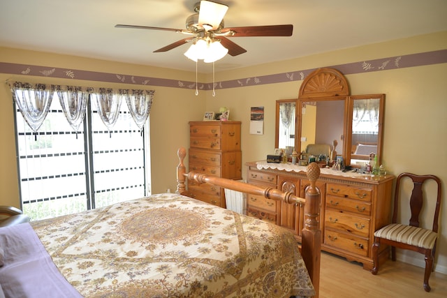 bedroom with light hardwood / wood-style flooring, access to exterior, and ceiling fan