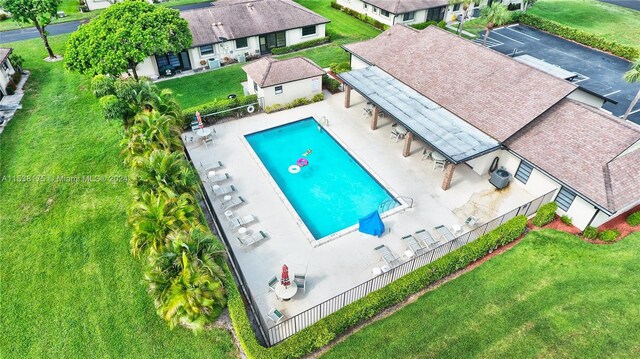 view of pool with a yard