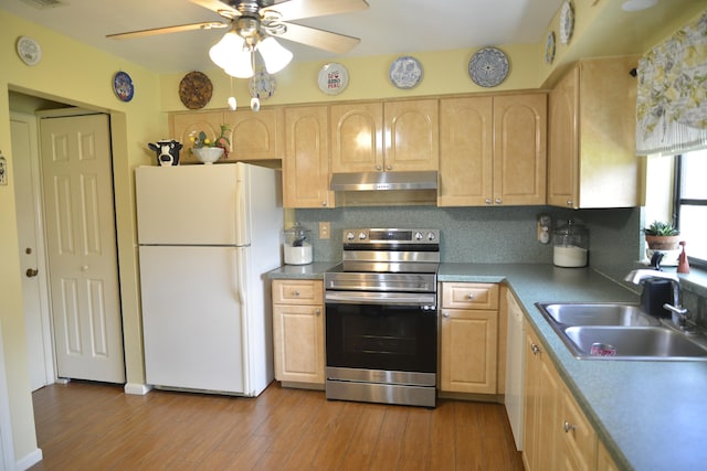 kitchen with sink, hardwood / wood-style flooring, white appliances, and backsplash