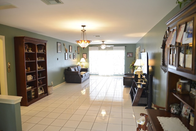 living room featuring light tile patterned flooring and ceiling fan