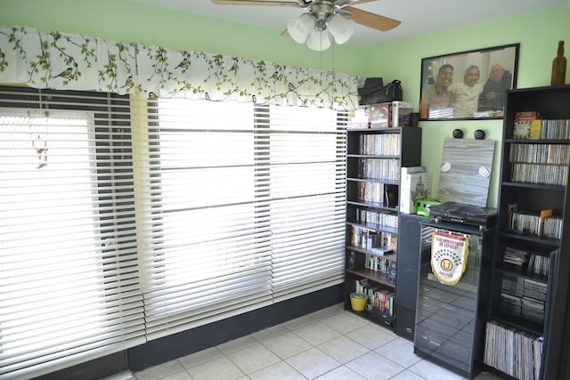 interior space featuring tile patterned flooring and ceiling fan