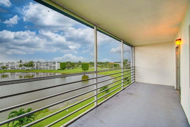 unfurnished sunroom with a water view