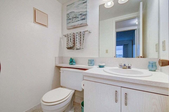 bathroom featuring tile patterned floors, toilet, and vanity