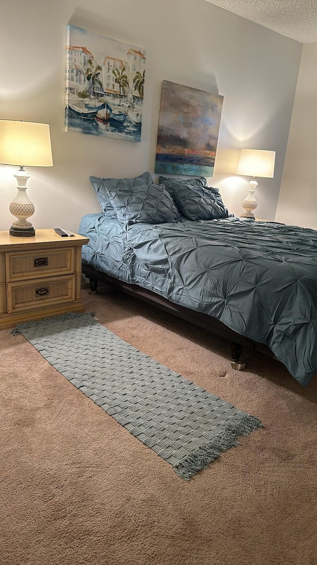 carpeted bedroom featuring a textured ceiling